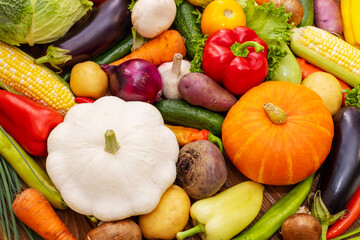 Assortment of the fresh ripe vegetables on wooden background. A collection of fresh and delicious vegetables. Healthy organic food concept