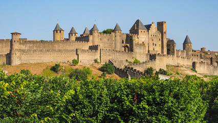 Famous hilltop town or ancient fortress La Cité de Carcassonne with medieval citadel or castle...