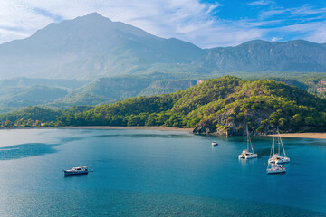 sea bay among the mountains with some yachts, view of the South Harbor of the ancient city of Phaselis, Turkey