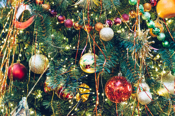 Multicolored christmas balls on a christmas tree close-up