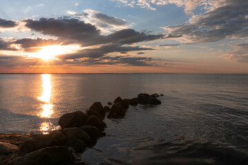 Fototapeta na wymiar Atmospheric coastline with dramatic sky by the Baltic Sea at sunset.