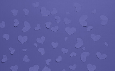 Many purple hearts on a purple background. Festive background. Background for design. Top view. St. Valentina