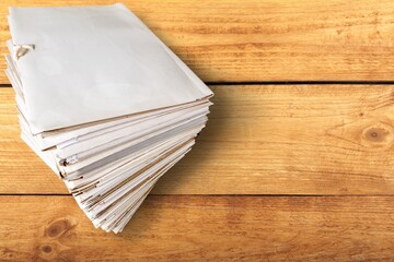 Stack of blank paper with binder clips on table indoors