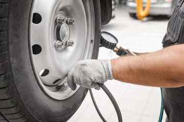 Cheking air pressure in automobile car wheel after tyre fitting or tire replacing for winter type