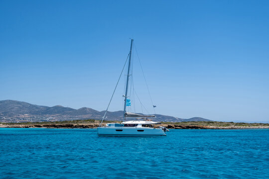 Luxury yacht anchored in emerald water. Panteronisi islet, between Paros Antiparos Cyclades Greece..