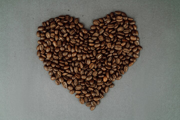 Close Up of Coffee Beans Shaped like a Heart on Dark Background