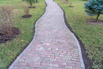 a stone path among the grass leading to nowhere