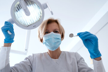 Professional doctor dentist check up and treating patient teeth