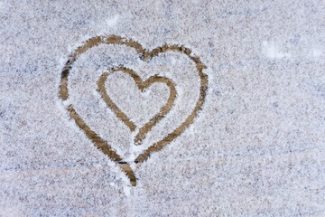 Drawing of two hearts on a wooden sidewalk covered with snow. Valentine's card on a white background.