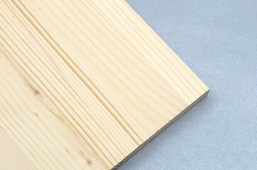 White pine board on a gray background. Wooden steps can be made of white pine.