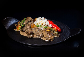 Meat in sauce and rice on a platter..