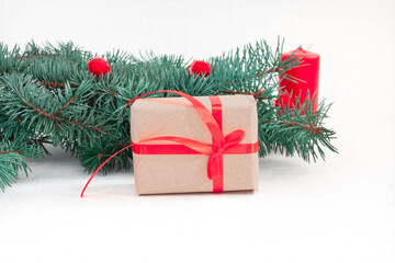 Merry Christmas happy New Year concept. Handmade Gifts, red candles, christmas three, ribbons, craft paper. Side view, flat lay.