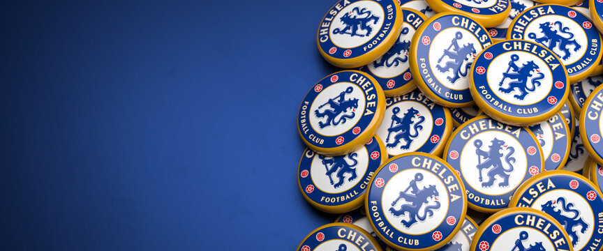 Logos of the English Soccer Club Chelsea FC on a heap on a table. Copy space. Web banner format