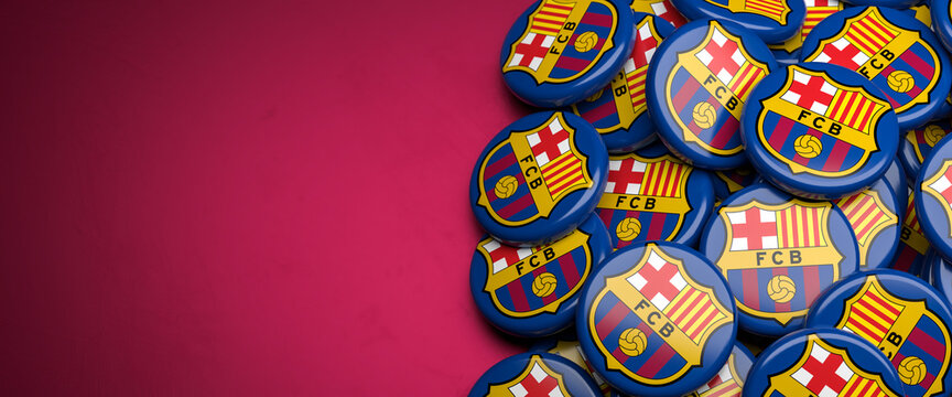 Logos of the Spanish Soccer Club FC Barcelona on a heap on a table. Copy space. Web banner format