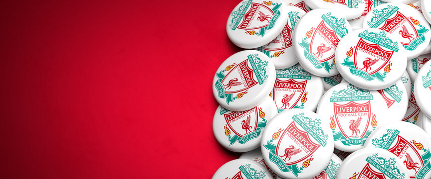 Logos of the English Soccer Club FC Liverpool on a heap on a table. Copy space. Web banner format