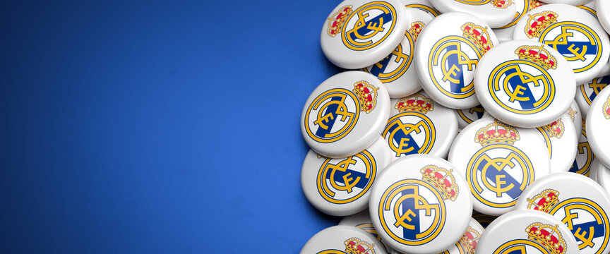 Logos of the Spanish Soccer Club Real Madrid on a heap on a table. Copy space. Web banner format