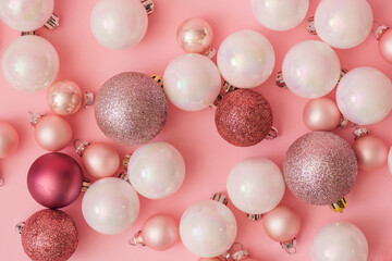 Christmas baubles decoration on pink background. New Year party background. Minimal style. Flat lay.
