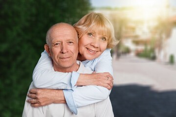 Portrait of lovely happy elderly couple on morning outside in city park,