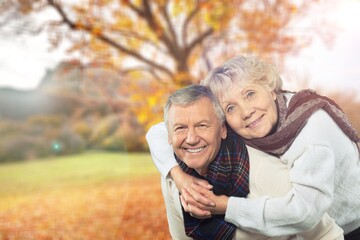 Portrait of lovely happy elderly couple on morning outside in city park,