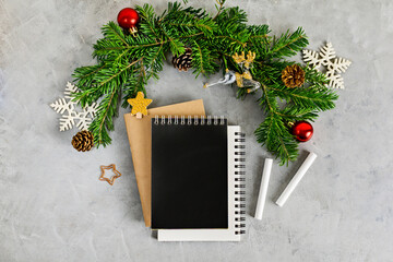 Top view flat lay christmas mockup with stack of notebooks and chalk. Wish list, holidays concept. Text space