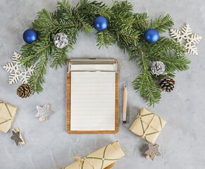 Top view flat lay christmas mockup with decorated pine tree, notes and pencil. Wish list, holidays concept. Text space