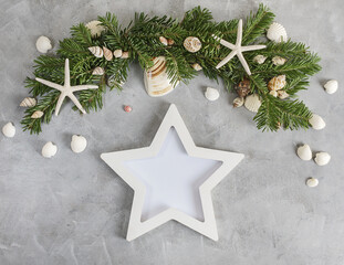 New year mockup: pine tree branches with star shaped photo frame on grey background. Tropical christmas, holidays concept. Text space