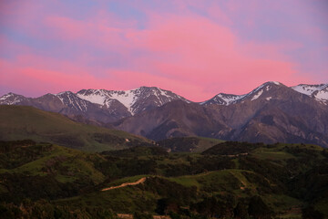 Fototapeta premium Snowy mountain peaks at sunrise