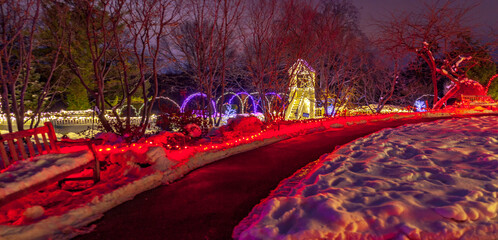 Winter park trail at night with Christmas lights and decor