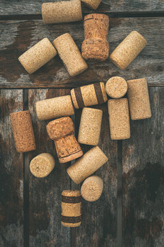 Overhead view of assorted corks on a wooden table
