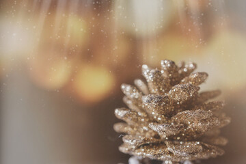 Fototapeta na wymiar golden christmas cone on the background of bokeh in closeup