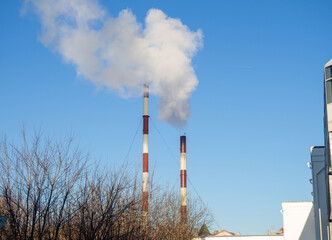 Pipes with smoke in winter.   Unfavorable ecology. Problems of the modern world
