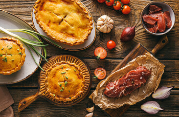 Tasty beef pot pies with meat on table