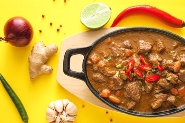 Dish with tasty beef curry on color background