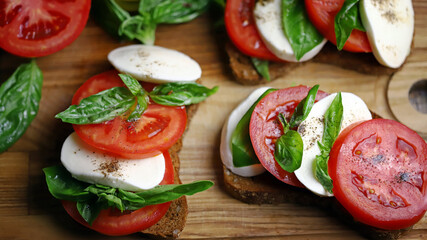Selective focus. Caprese sandwiches on the board. Healthy snack. Italian food.