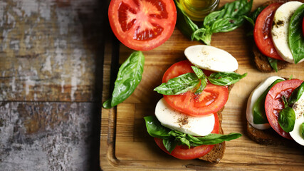 Selective focus. Caprese sandwiches on the board. Healthy snack. Italian food.