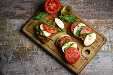 Selective focus. Caprese sandwiches on the board. Healthy snack. Italian food.