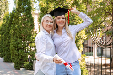Happy young woman with her mother on graduation day