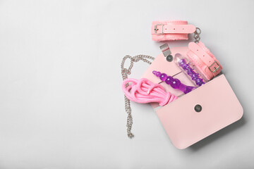 Bag with sex toys on light background
