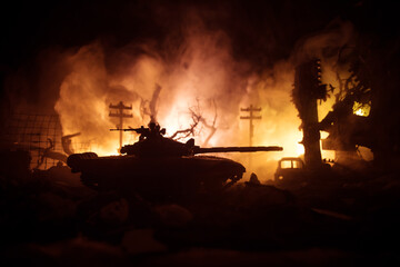 Fototapeta premium War Concept. Military silhouettes fighting scene on war fog sky background, World War Soldiers Silhouette Below Cloudy Skyline At night. Battle in ruined city.