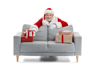Santa Claus behind sofa with Christmas presents on white background