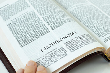 Deuteronomy Holy Bible Book. A close-up of open Old Testament Scripture. Second Law by God Jesus Christ. A Christin biblical concept of hope, faith, trust in the LORD. Studying the Torah.