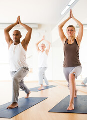 Group yoga classes in a modern fitness center