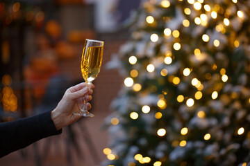 Human hands with glasses of champagne on a Christmas or New Year background