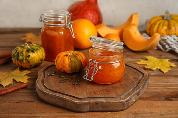 Jars of sweet pumpkin jam on table