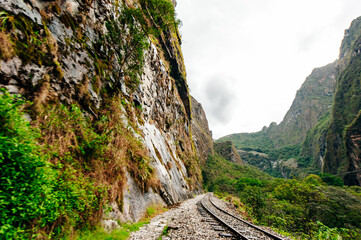 The railroad track crossing jungle and Urubamba river, connecting Machu Picchu village to...