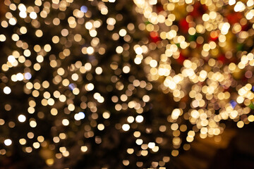 New Year's or Christmas background with light bulbs and trees. Bokeh or blur background