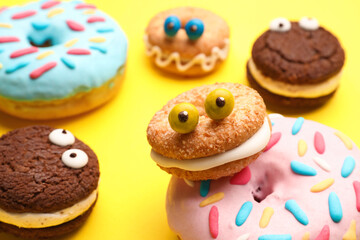 Funny cookies with donuts on color background