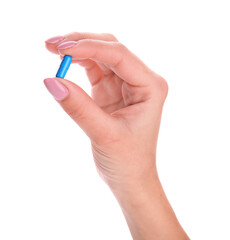 Hand with blue pill isolated on white