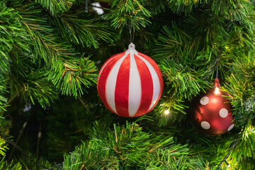 Happy New Year Christmas tree decorates on background bokeh of side flickering light bulbs garlands...