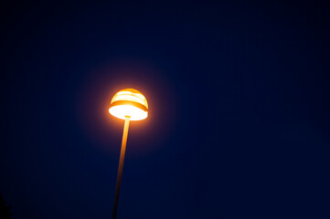 Street light towards a dark night sky